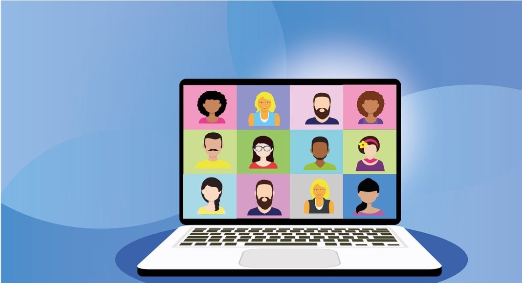 "Person using laptop with monitor displaying computer hardware on screen"